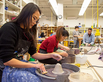 Students work with clay in art class