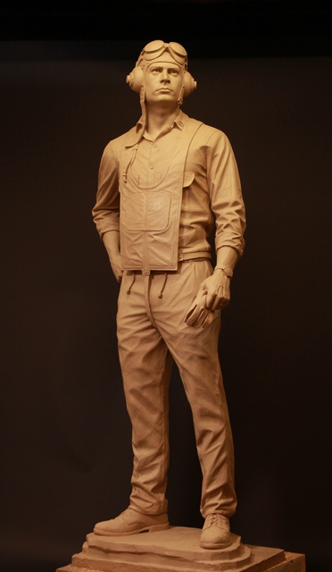Tan statue of pilot Cecil Harris in historic flight uniform, looking into the distance