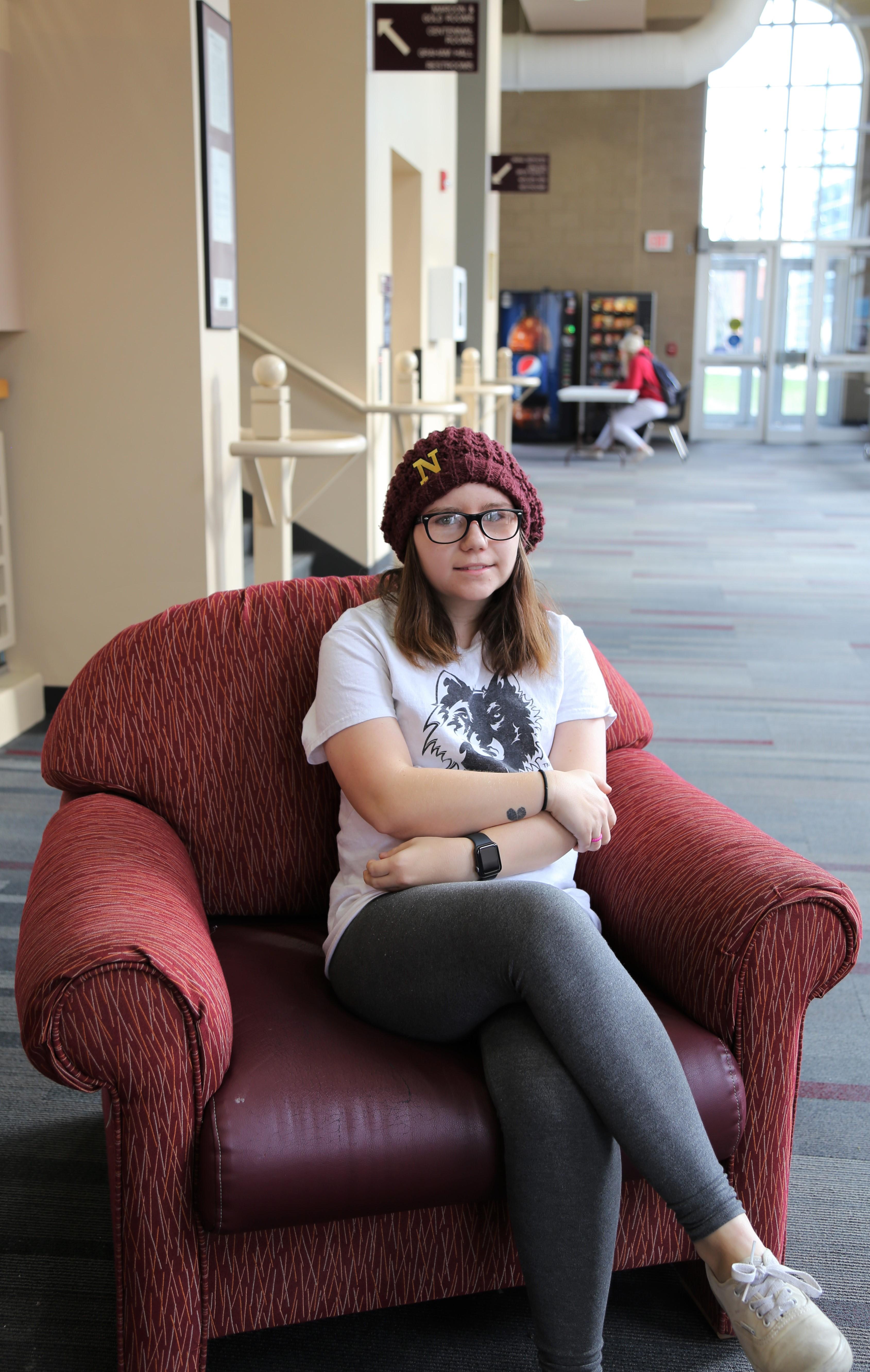 Student sitting on chair in student center