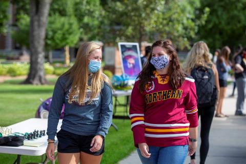 Students wearing masks walking on campus