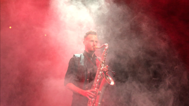 NSU alumnus playing a saxophone