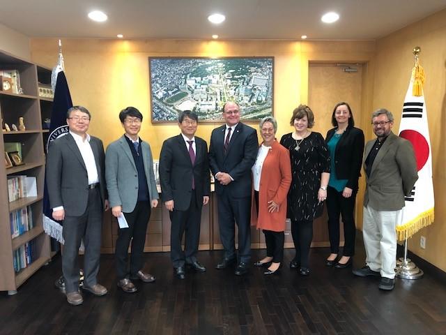 NSU delegation standing with representatives of South Korean university
